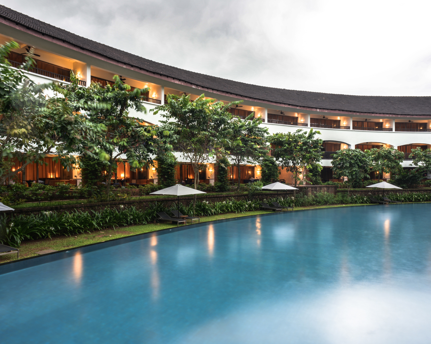 Pool in the foreground with The Diwa Club exterior in the background.