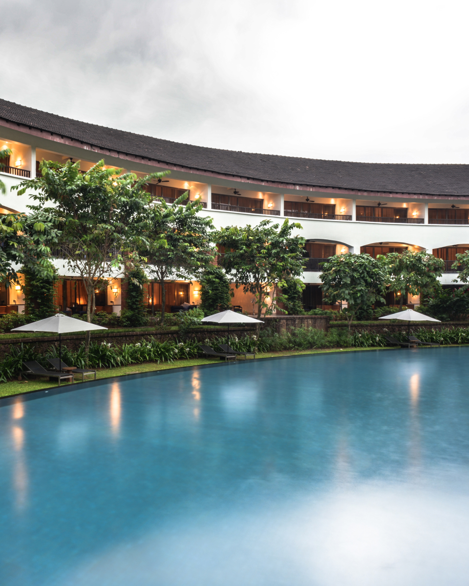 Pool in the foreground with The Diwa Club exterior in the background.