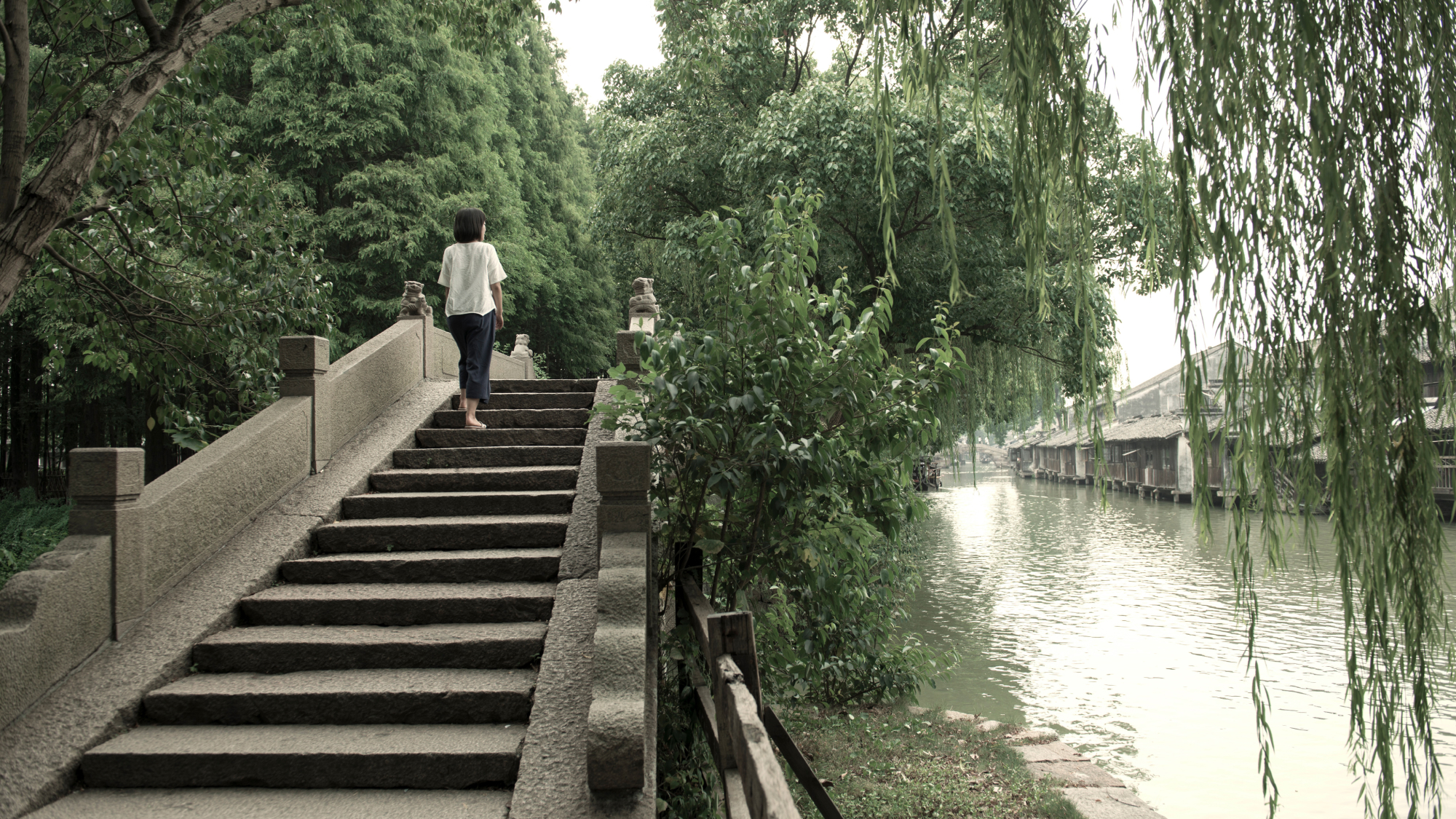 Person walking on staircase next to waterway