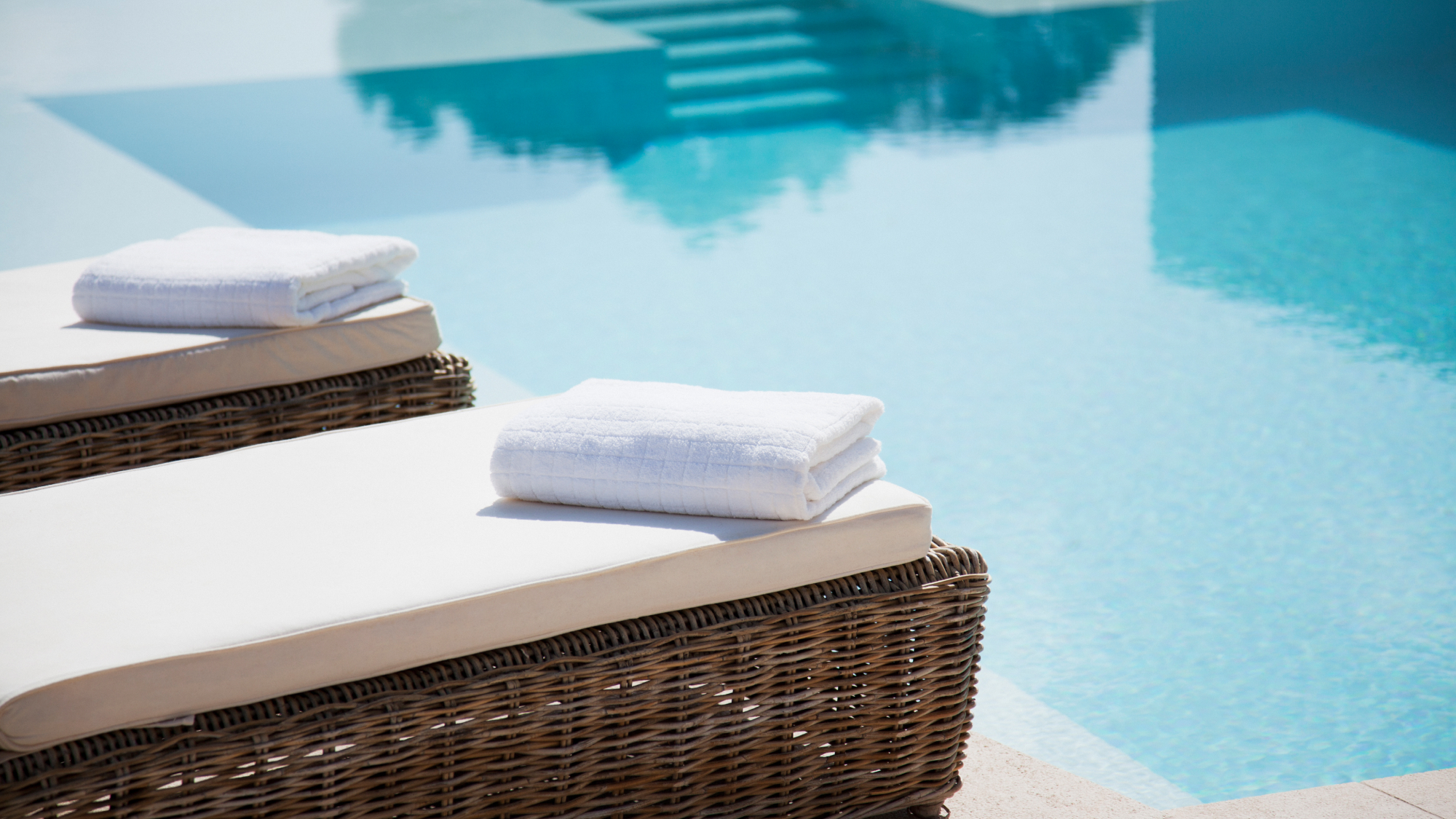 towel placed on sun beds by the pool