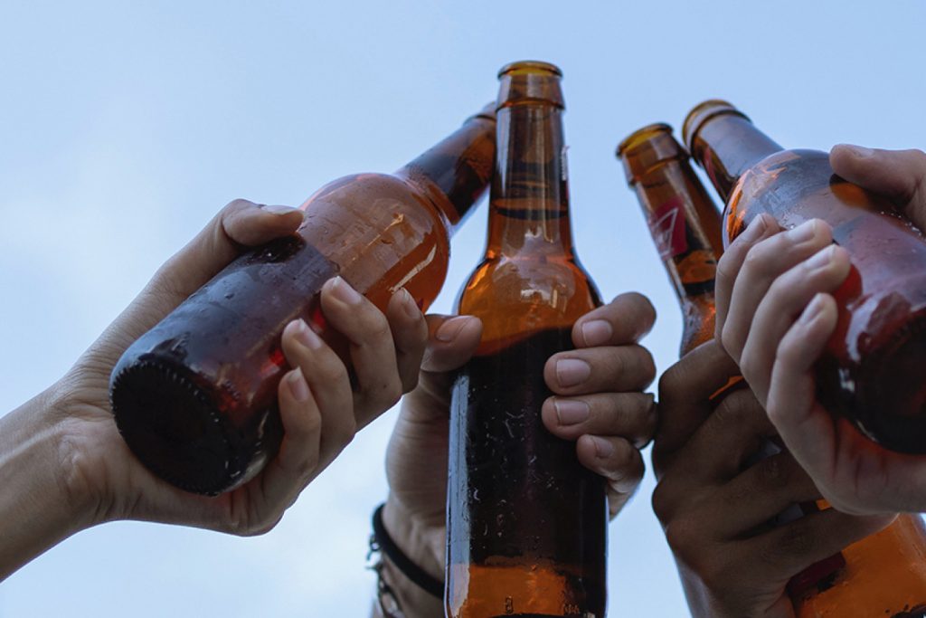 hands cheering with beer bottles