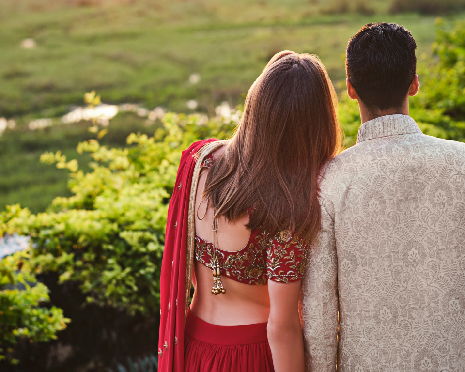 couple looking out to field in traditional clothing