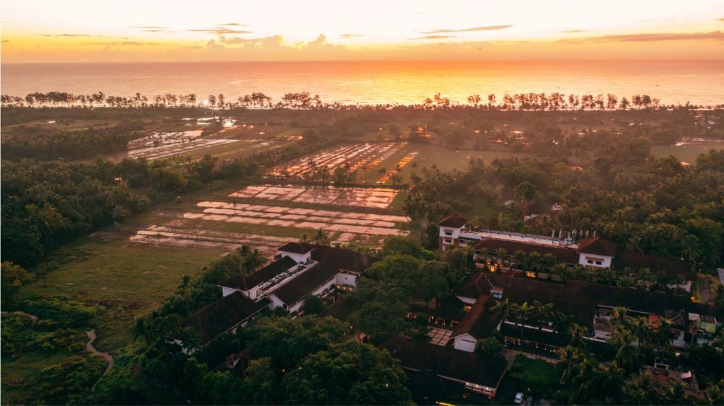 aerial view of hotel property at sunset
