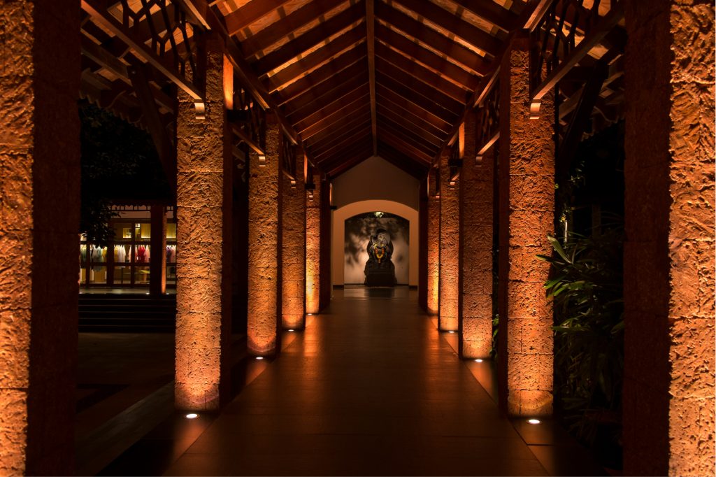 dimly lit outdoor walkway with columns