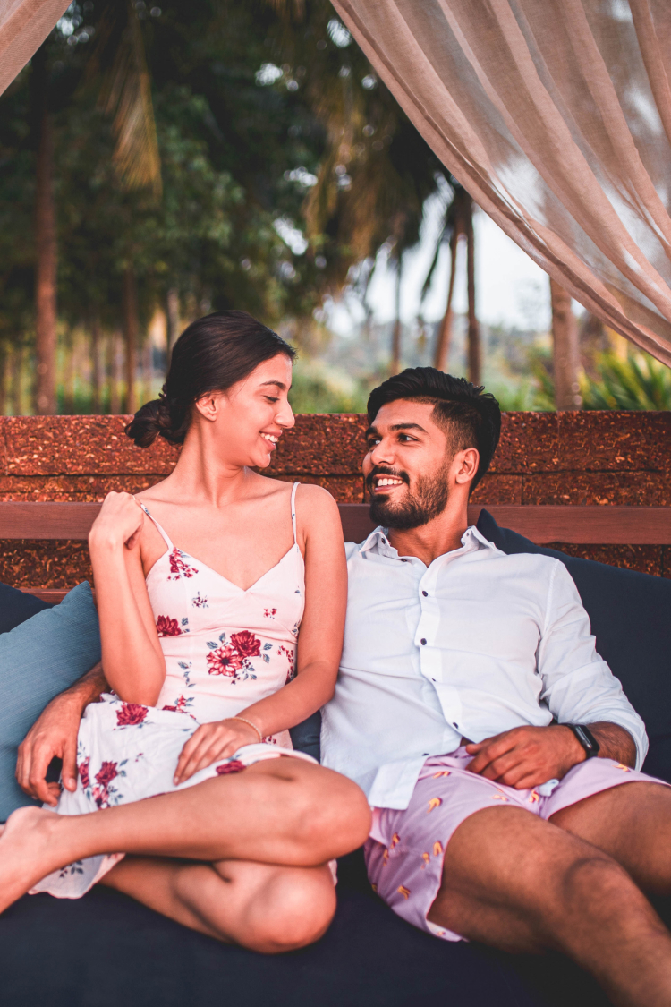 Couple sitting next to each other on cabana seating