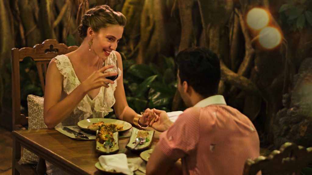 couple enjoying a meal and wine