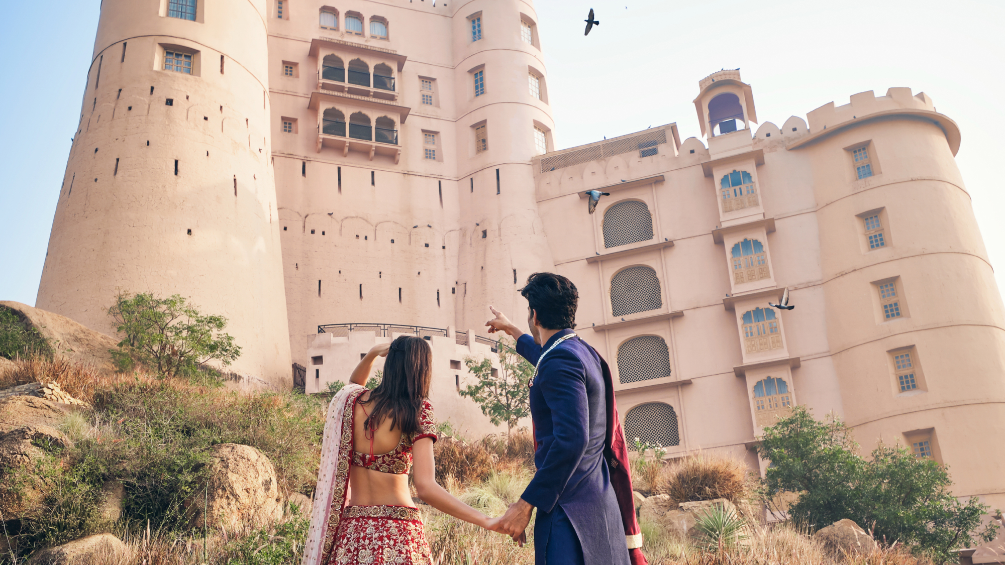 couple looking up at fort bishangarh