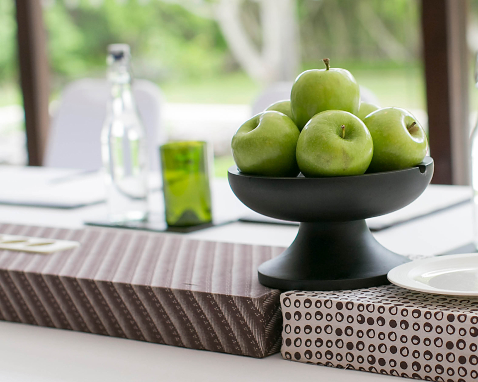 Bowl of apples on a meeting table.