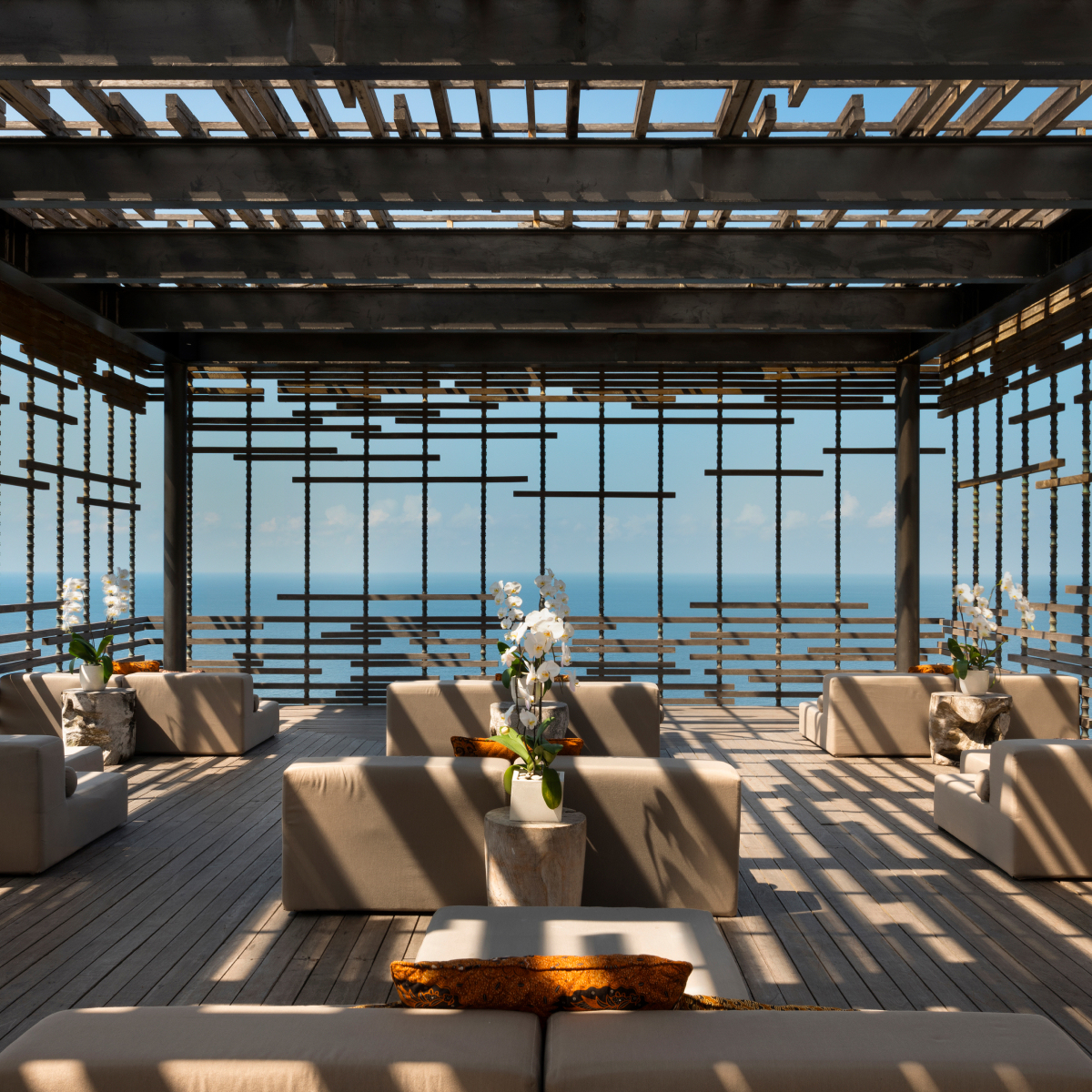 Covered patio with nine couches facing the ocean