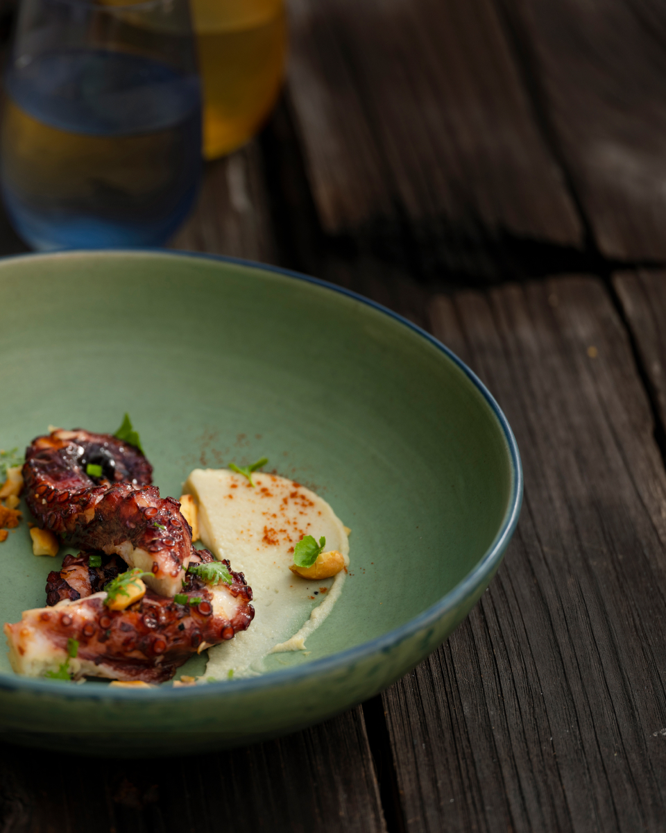 Plated dish showing grilled octopus in a bowl