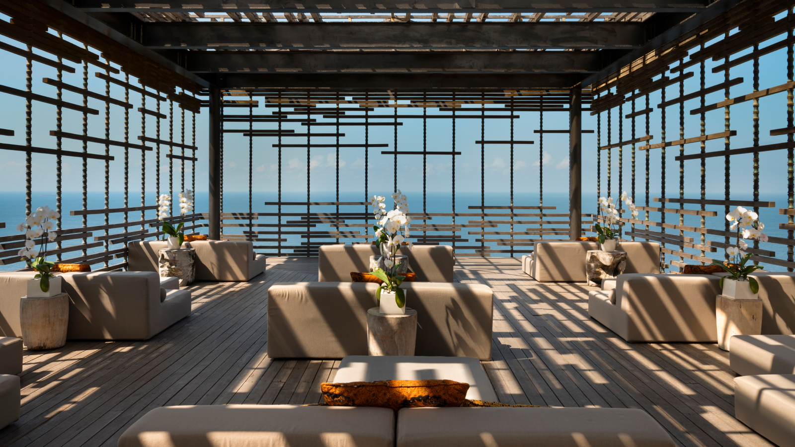 Covered patio with nine couches facing the ocean