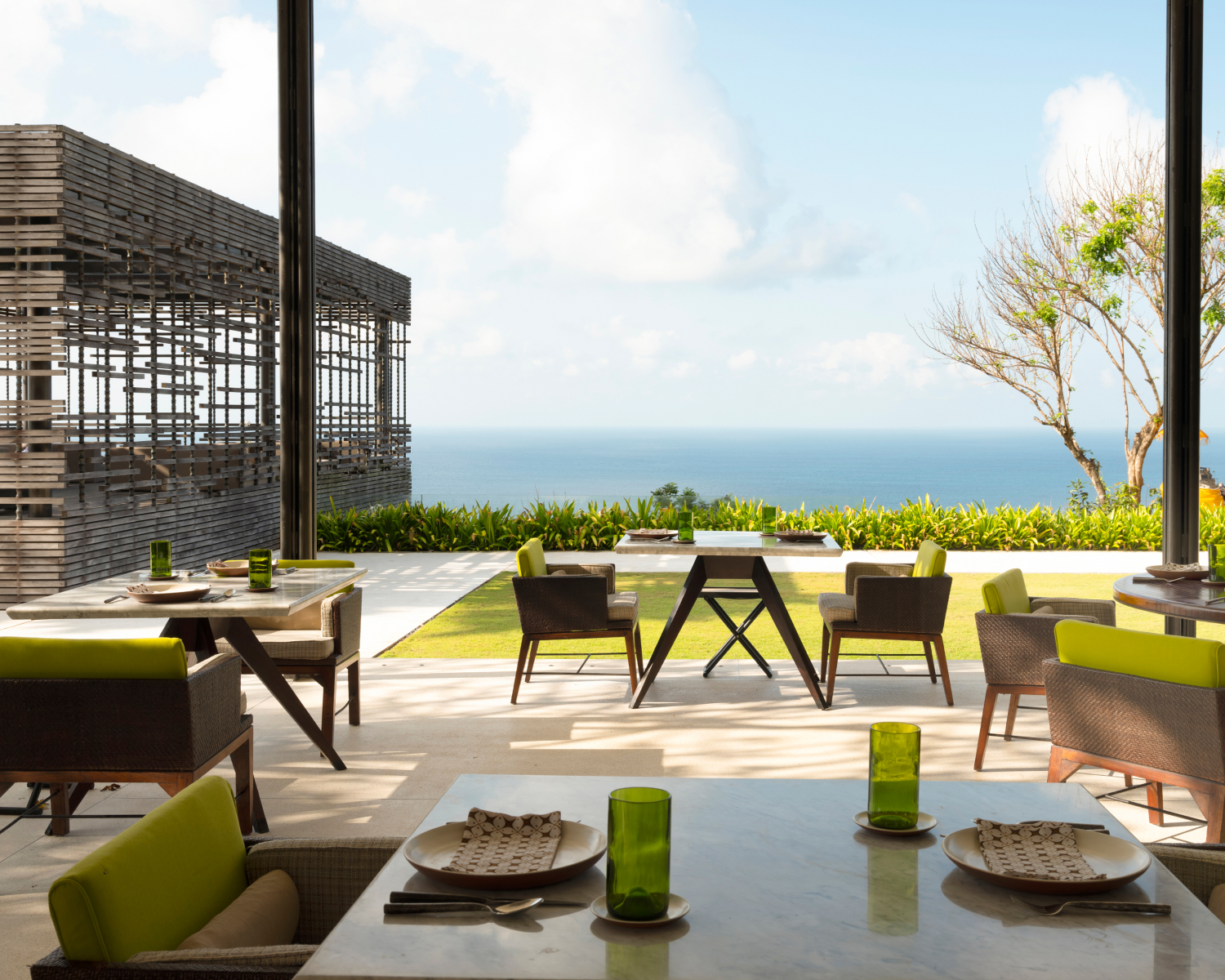 Warung outdoor dining under a covered patio overlooking the ocean