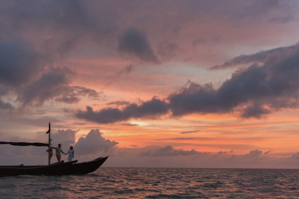 couple on a boat at sunset