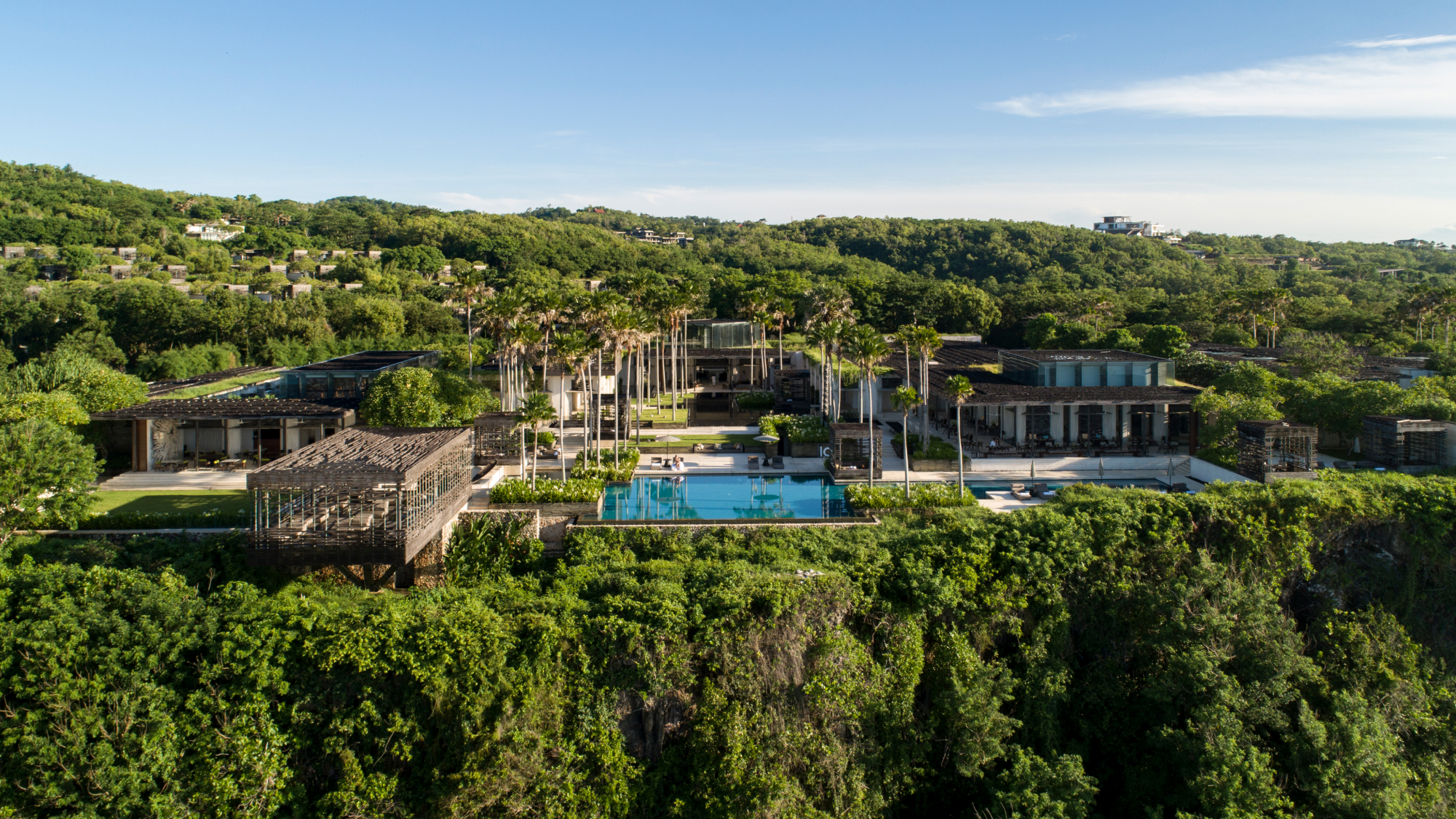 Villa shot from cliff edge in lush greenery
