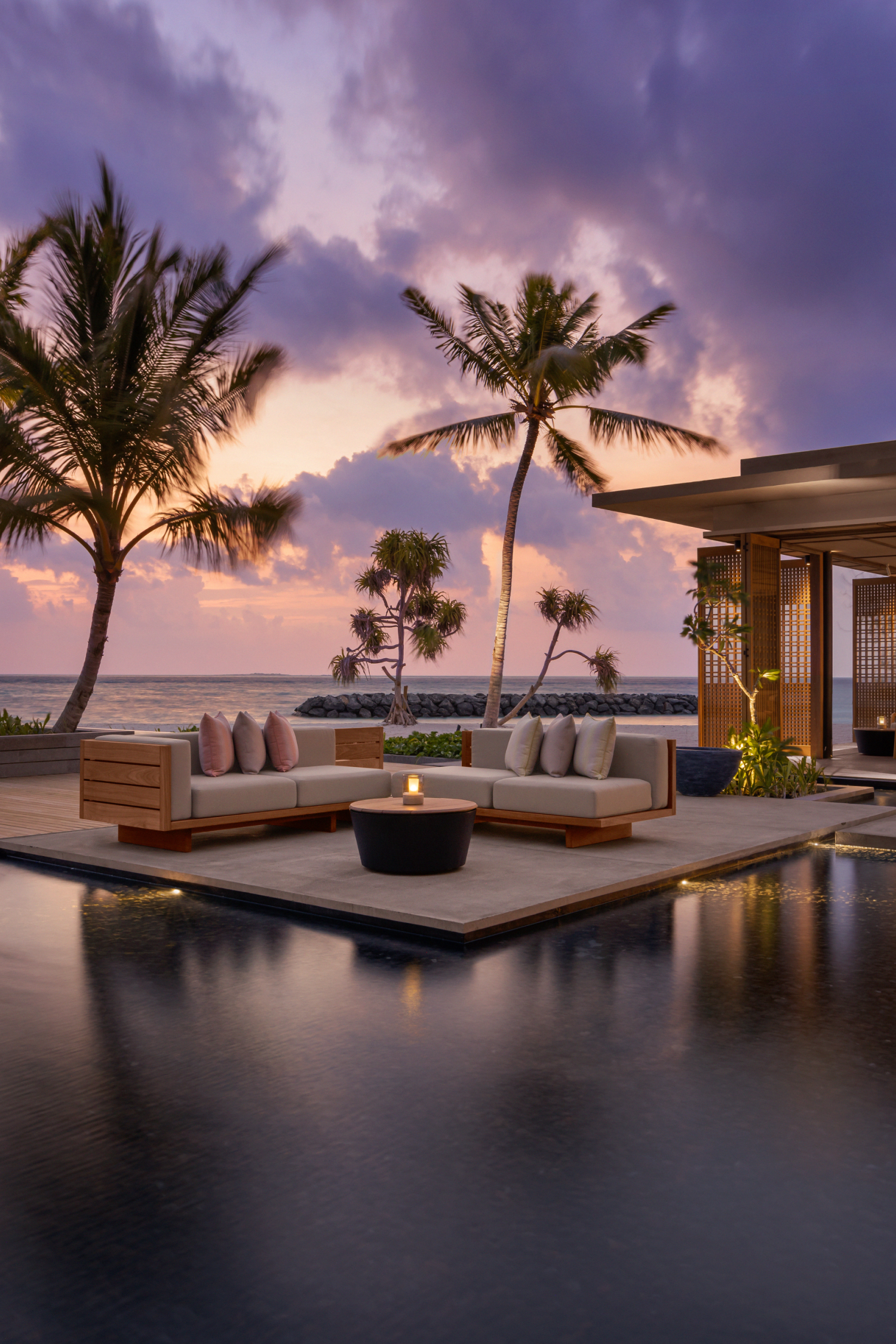 Lounge area by pool at sunset
