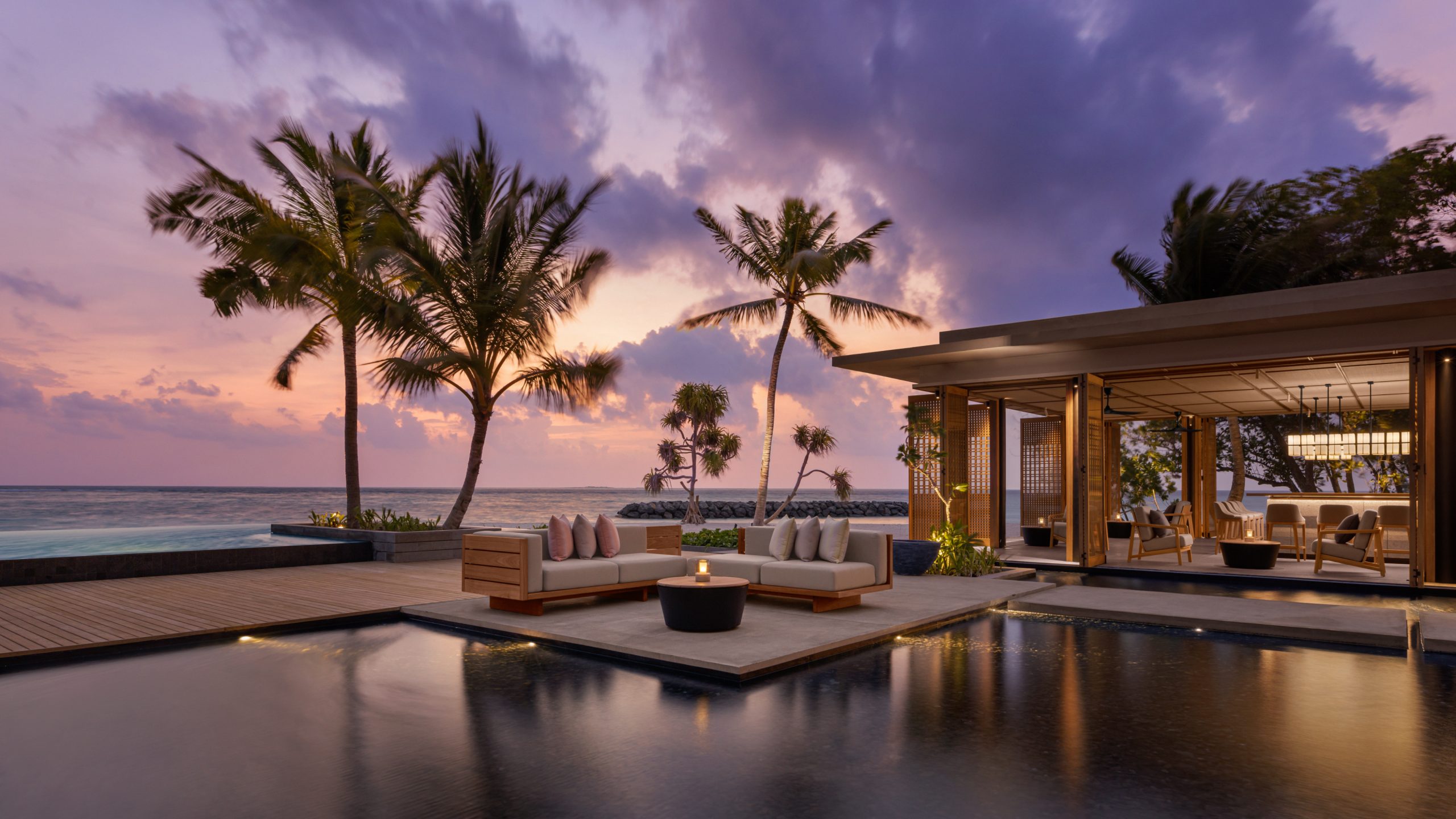 Lounge area by pool at sunset