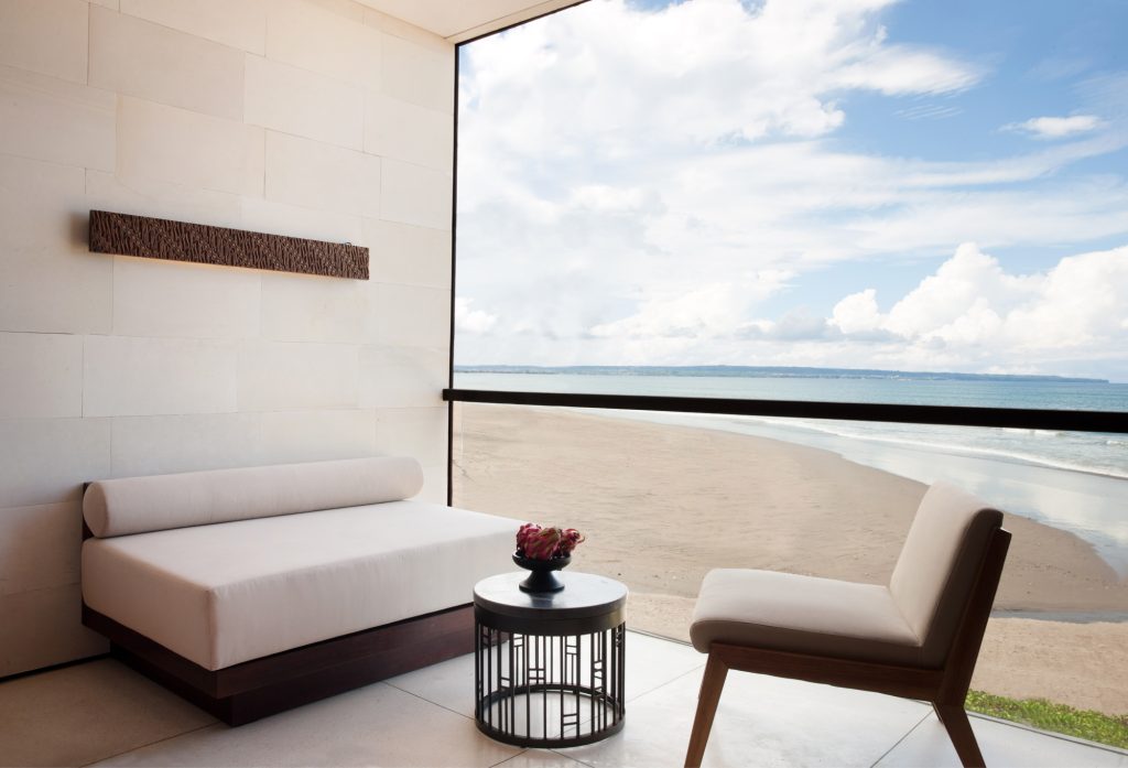 Private terrace with couch and chair overlooking the ocean.