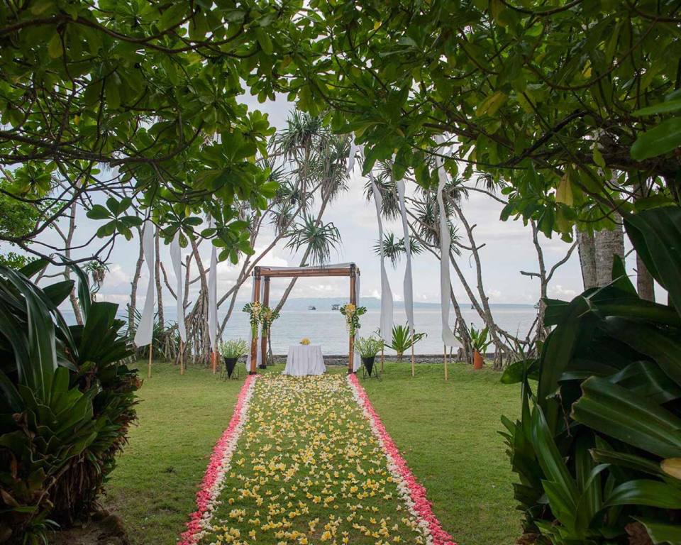 Aisle made of flowers on grass for outdoor wedding