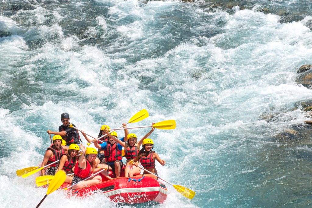 group of people white water rafting