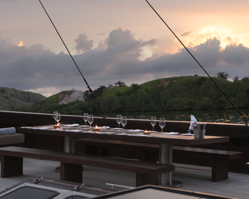 dining table set on the deck of a boat